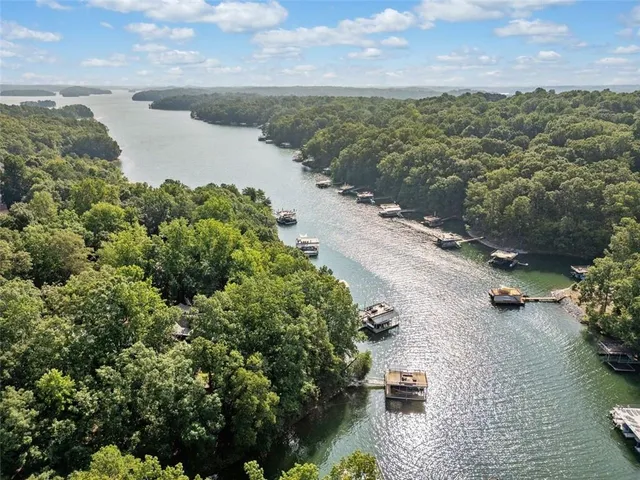 an aerial view of a house with a yard and lake view