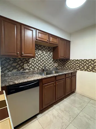 a kitchen with stainless steel appliances granite countertop a stove microwave and refrigerator