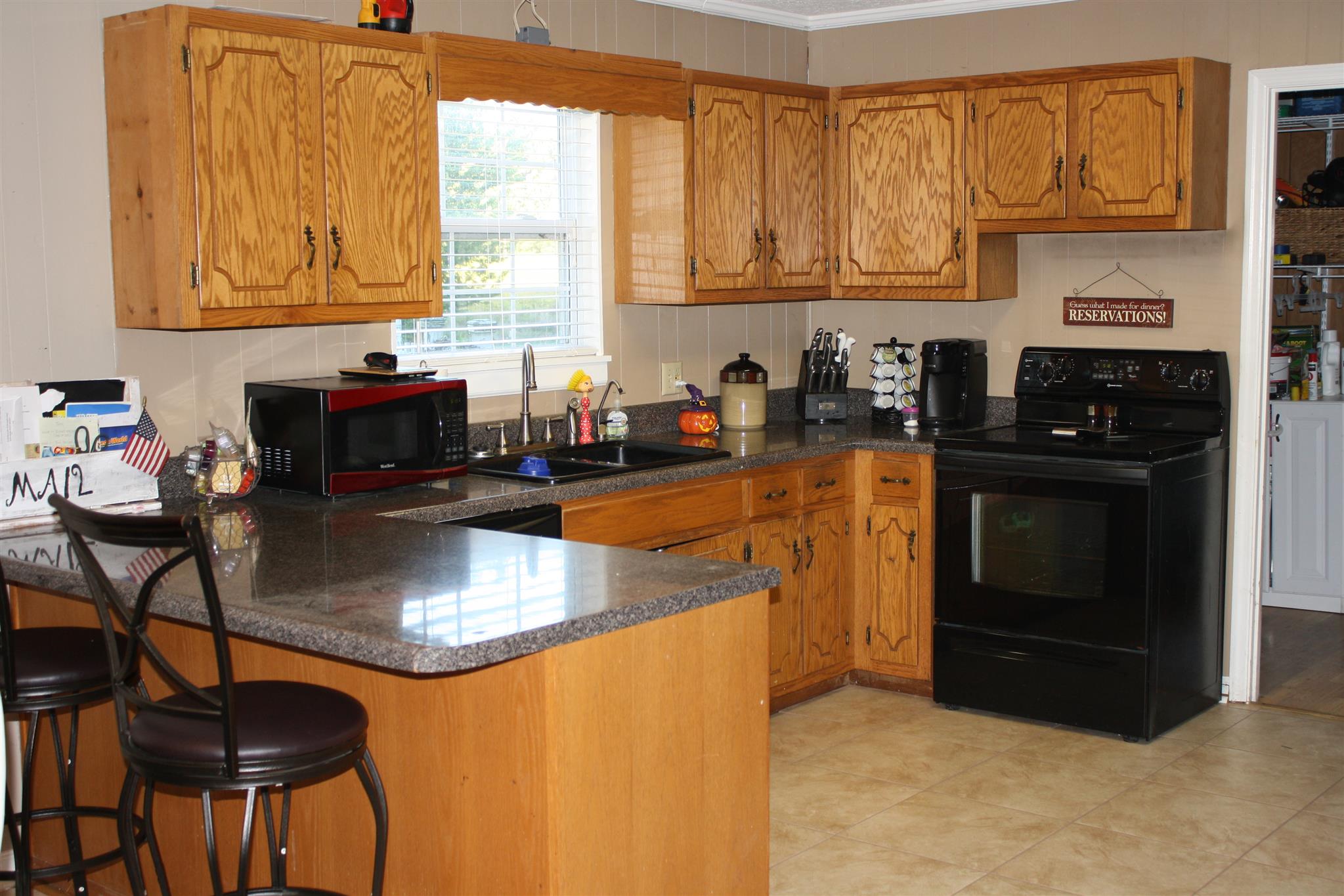 245 South Leath Road Portland, TN 37148 - Photo 5 of 19 a kitchen with stainless steel appliances granite countertop a stove a sink a microwave and a refrigerator