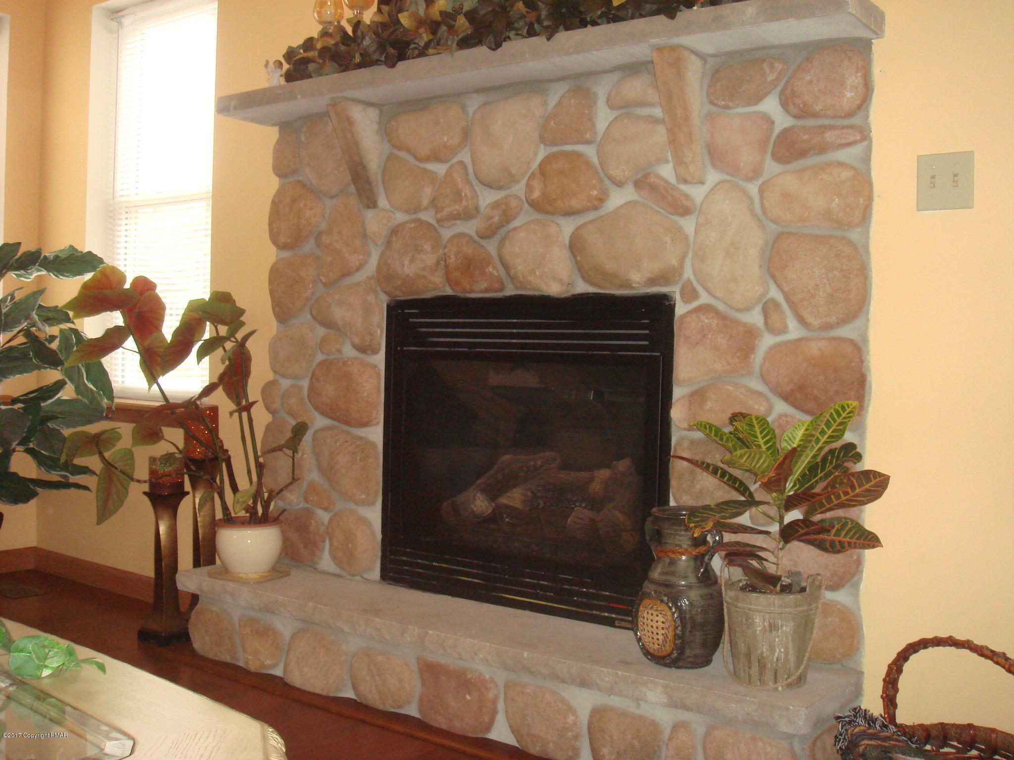 605 Gandolf Road Tamiment, PA 18371 - Photo 7 of 35 Family Room Stone Faced Gas Fireplace