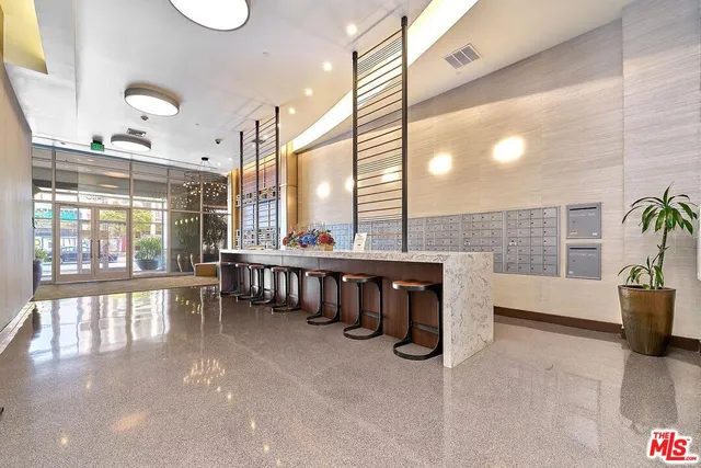 a lobby with furniture and a potted plant