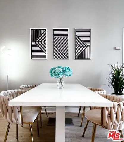 a dining room with furniture and wooden floor