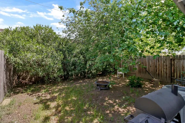a backyard of a house with yard and outdoor seating