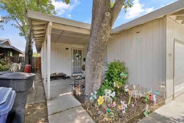 a front view of a house with outdoor seating