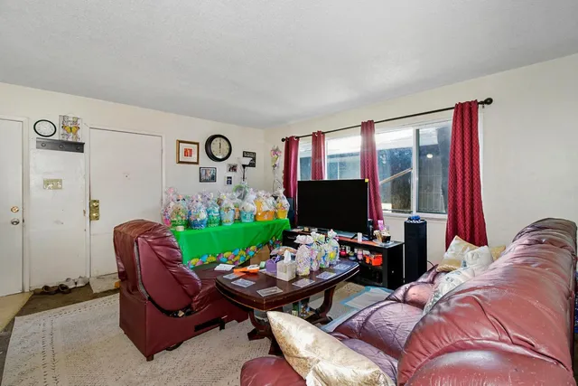 a very nice looking room with many windows and furniture