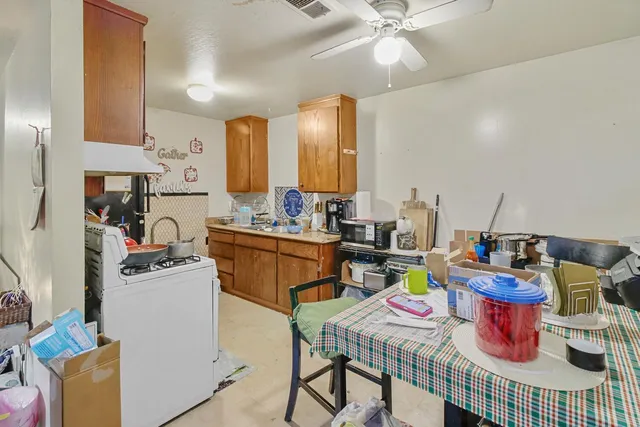 a kitchen with sink a stove and cabinets