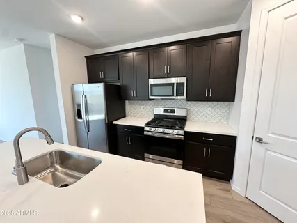 a kitchen with a refrigerator stove and sink