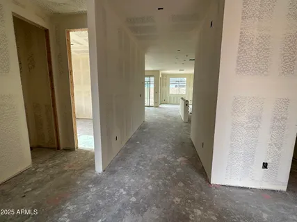 a view of a hallway with wooden floor and closet