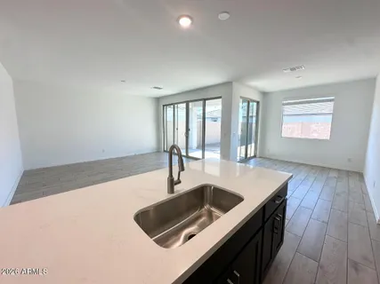 a kitchen with a sink and large window