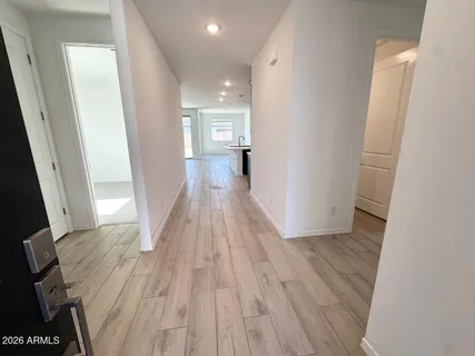 a view of a hallway with wooden floor