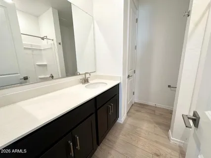 a bathroom with a double vanity sink and a mirror