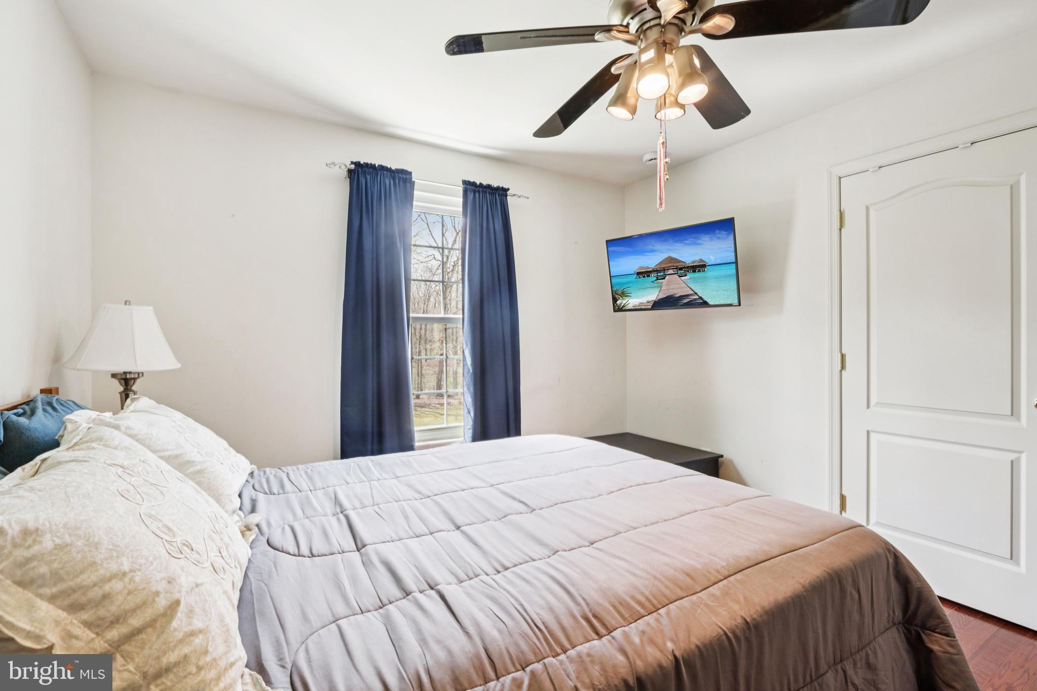 104 Ryans Run Sicklerville, NJ 08081 - Photo 45 of 94 a bedroom with a large bed and a chandelier