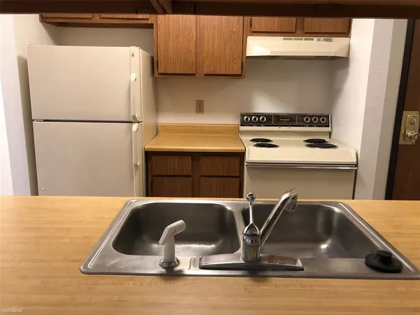 a kitchen with a sink and a refrigerator