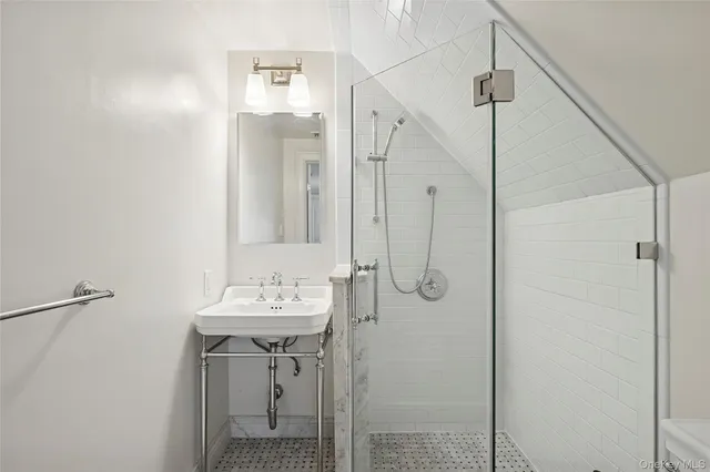 a bathroom with a sink a mirror and shower