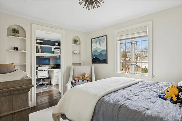 a bedroom with a bed and a view of living room