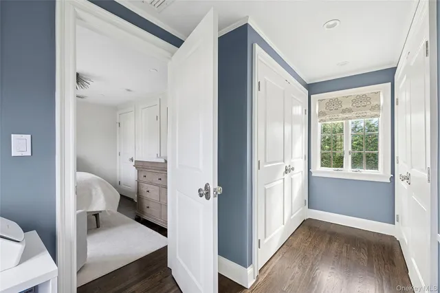 a view of a hallway with a livingroom and a bathroom with a sink