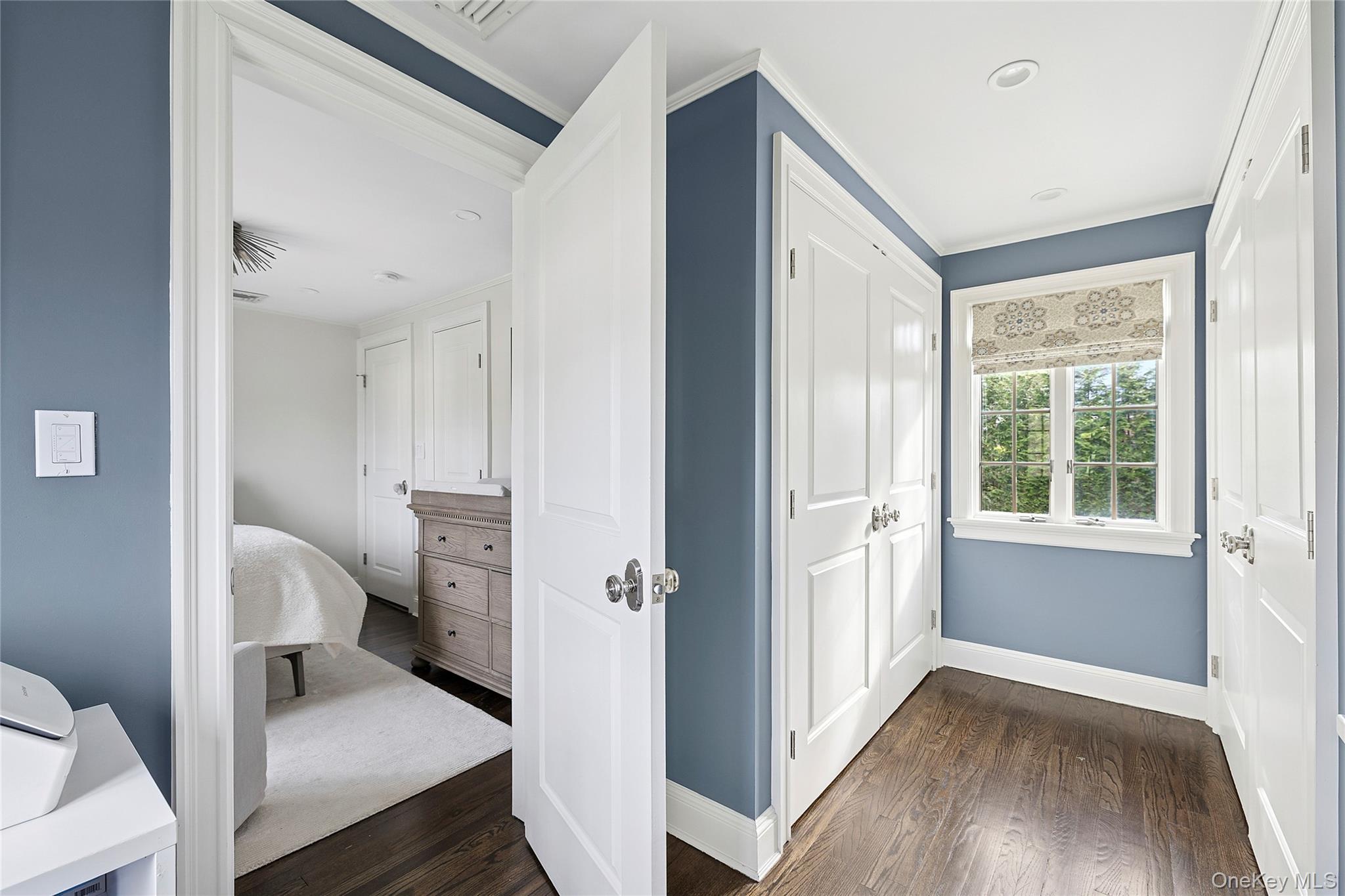 44 Old Ox Road Manhasset, NY 11030 - Photo 19 of 23 a view of a hallway with a livingroom and a bathroom with a sink