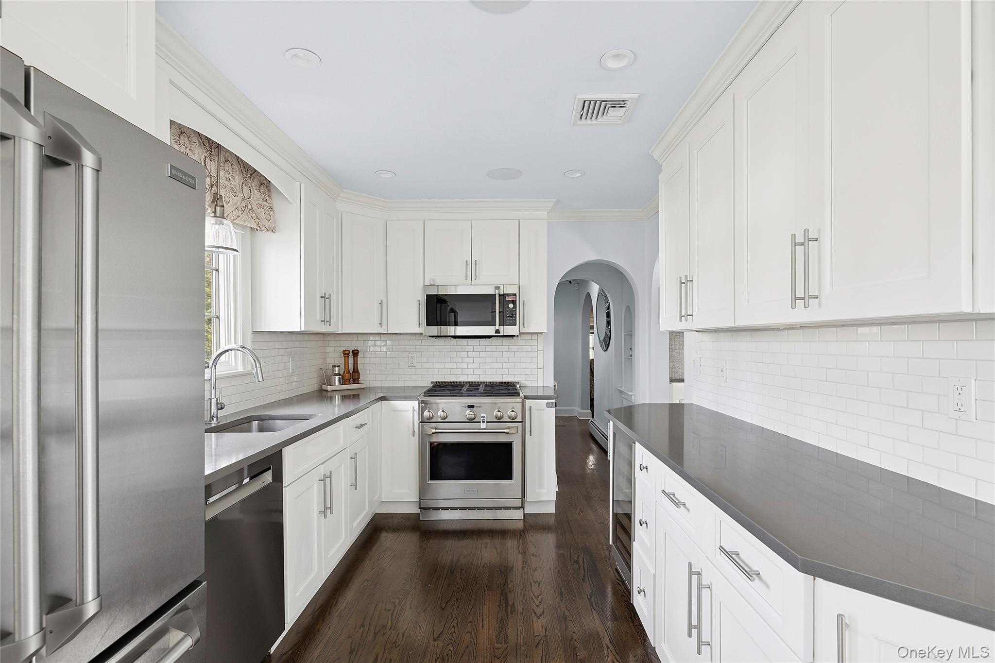 44 Old Ox Road Manhasset, NY 11030 - Photo 6 of 23 a kitchen with stainless steel appliances granite countertop a stove a sink dishwasher a refrigerator white cabinets and wooden floor