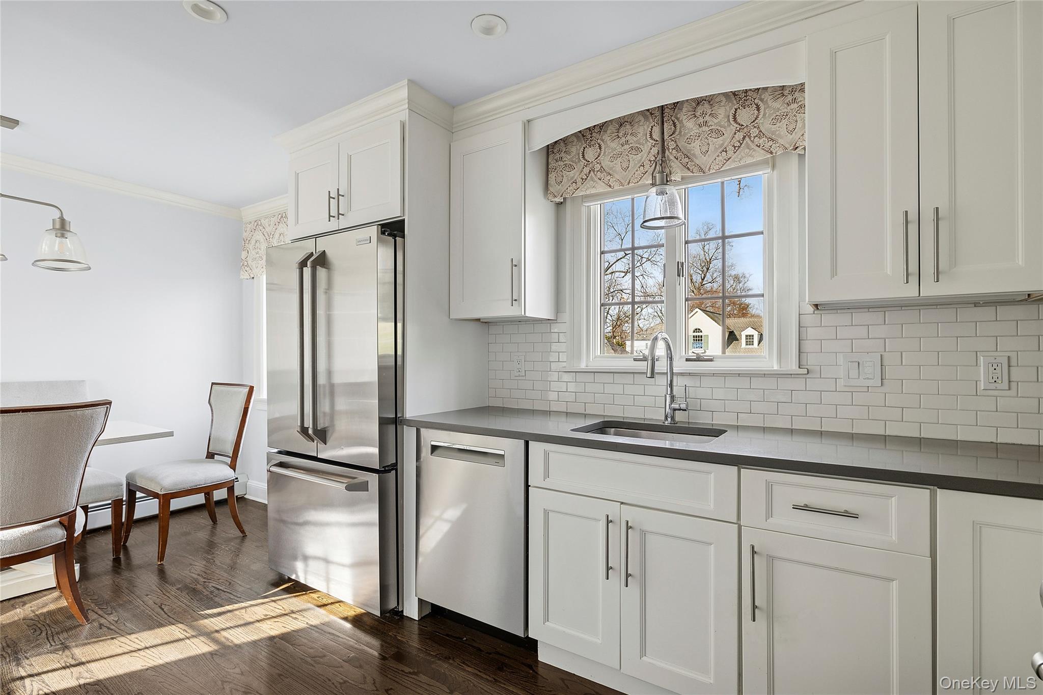 44 Old Ox Road Manhasset, NY 11030 - Photo 7 of 23 a kitchen with a sink cabinets and dining table chair