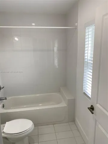 a bathroom with a bathtub and a toilet