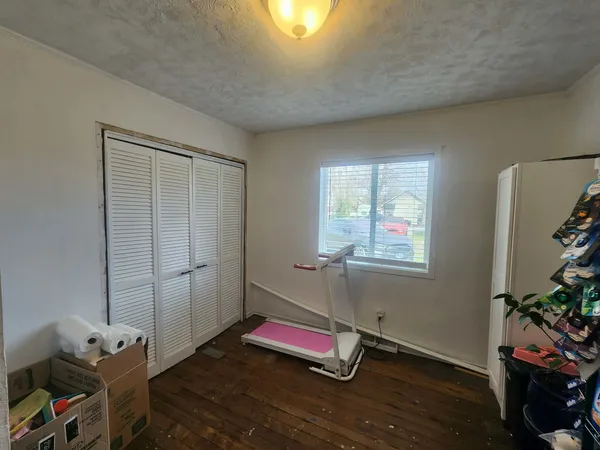 a room with gym equipment and a window