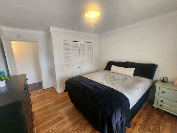 a bedroom with a bed and window