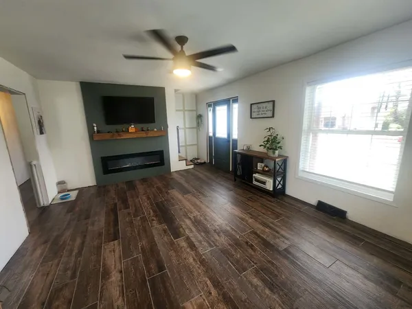 wooden floor in an empty room with a window