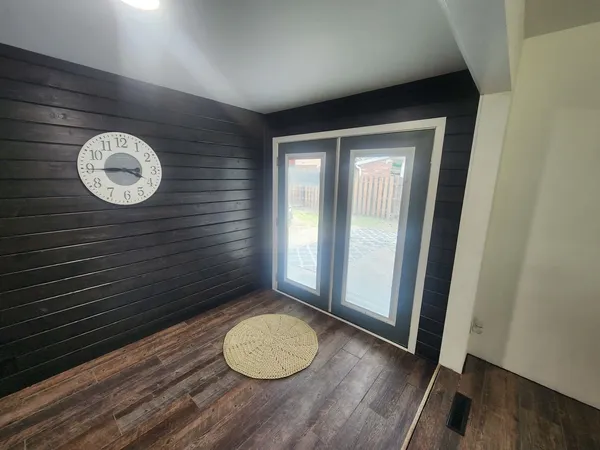 a view of a room with wooden floor