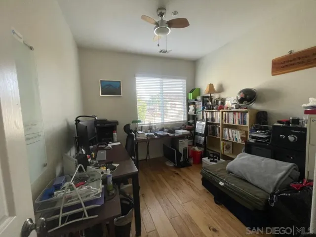 a work room with furniture and wooden floor