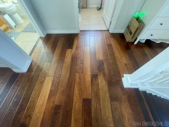 a view of hallway with wooden floor