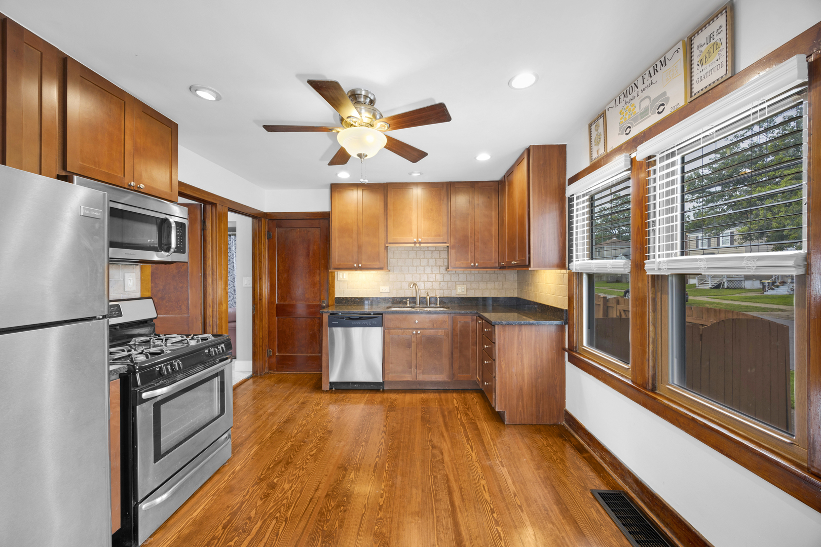 3403 Monroe Street Lansing, IL 60438 - Photo 3 of 10 a kitchen with stainless steel appliances a refrigerator a sink and white cabinets
