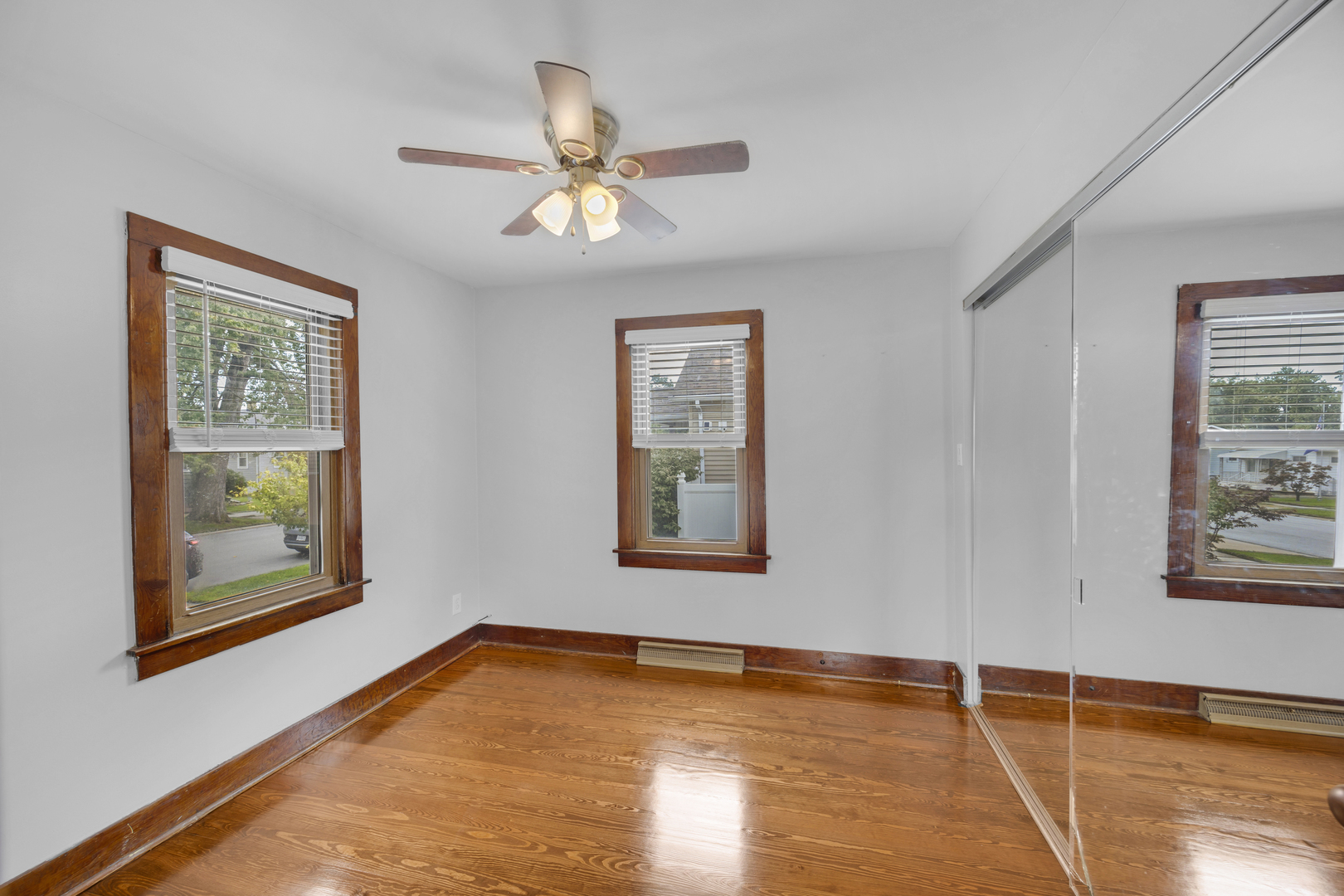 3403 Monroe Street Lansing, IL 60438 - Photo 4 of 10 a view of an empty room with window and wooden floor