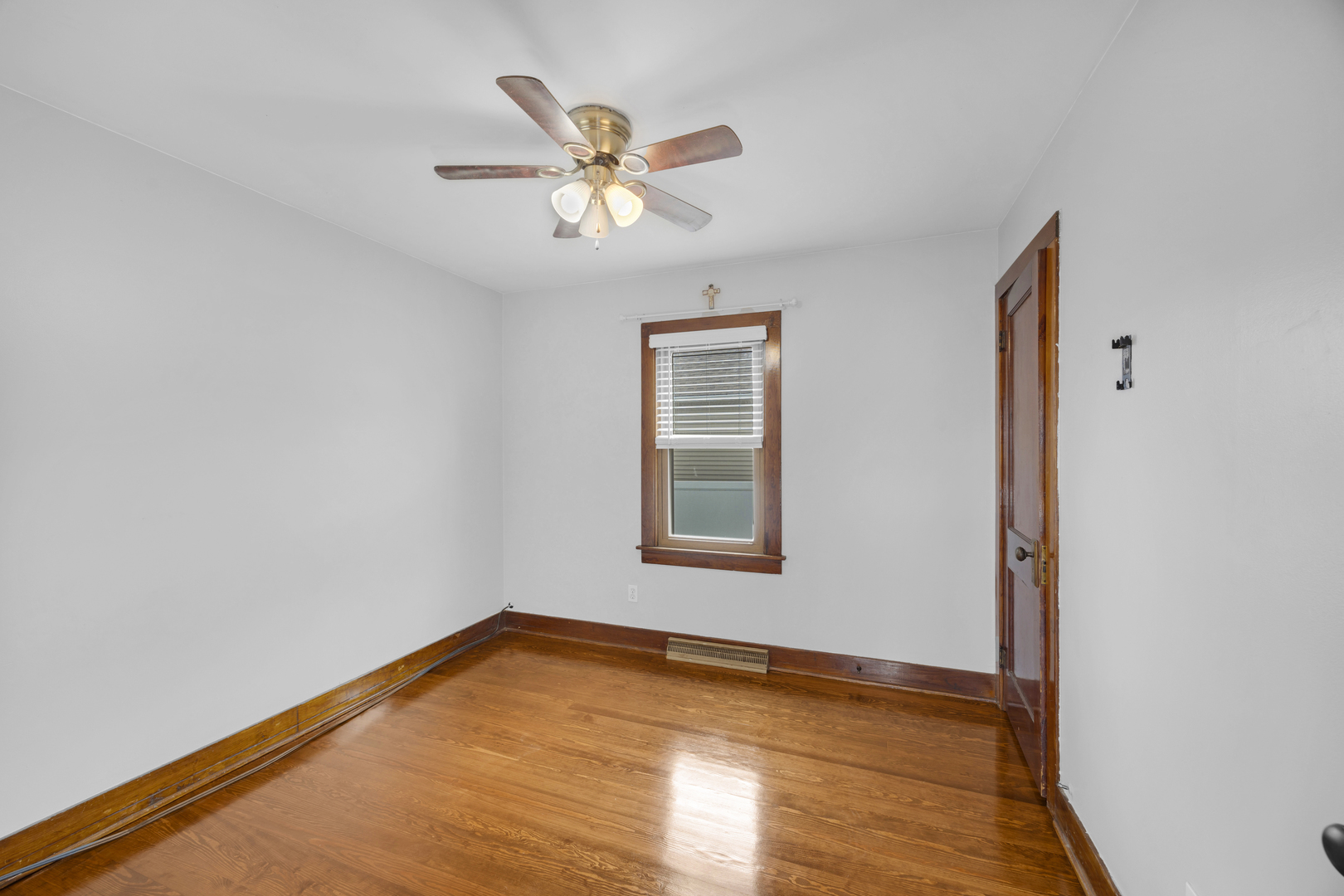 3403 Monroe Street Lansing, IL 60438 - Photo 5 of 10 a view of an empty room with wooden floor and a window