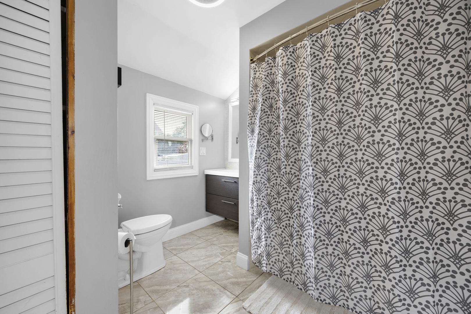 3403 Monroe Street Lansing, IL 60438 - Photo 6 of 10 a bathroom with a toilet and a shower curtain