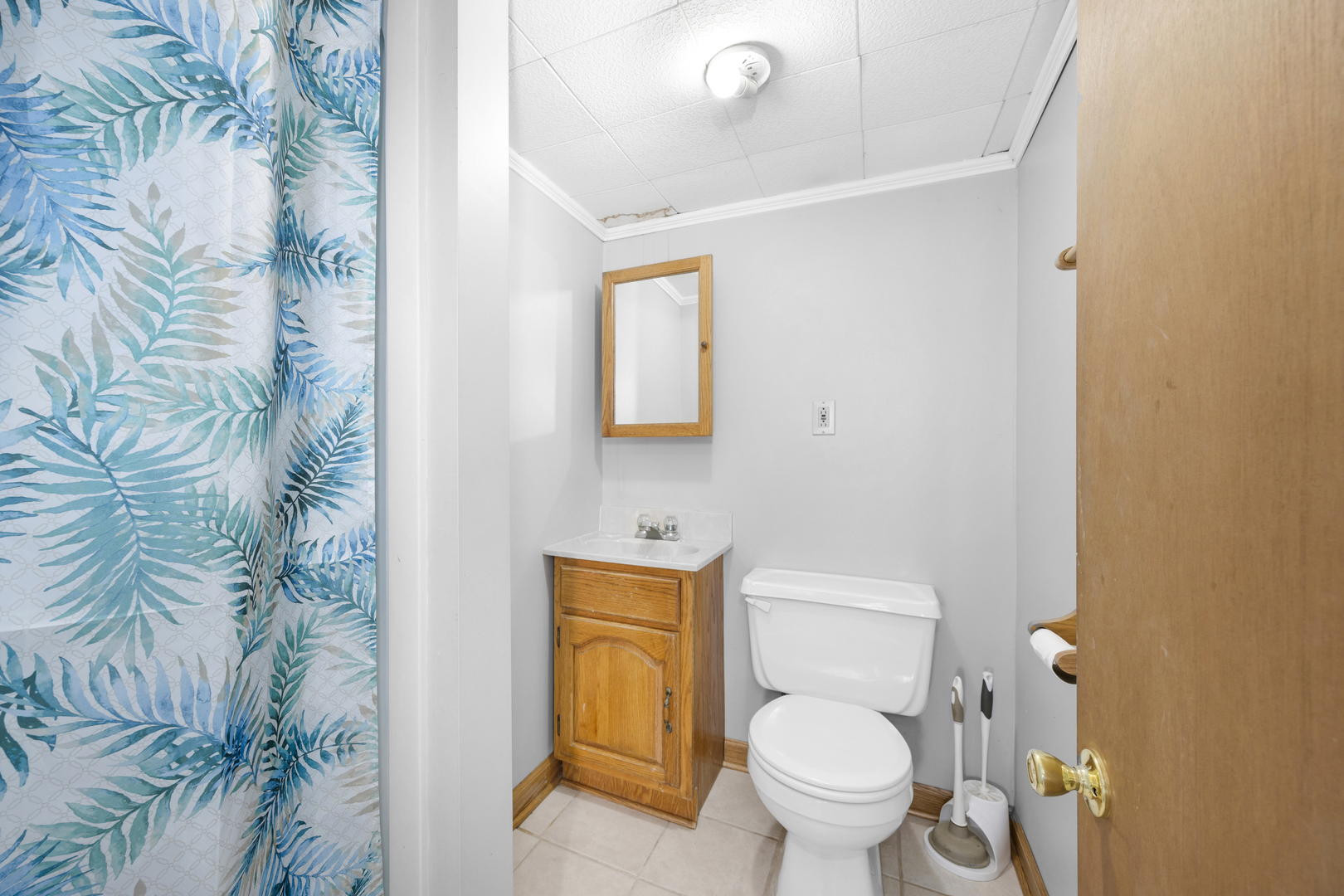 3403 Monroe Street Lansing, IL 60438 - Photo 9 of 10 a white toilet sitting next to a shower curtain