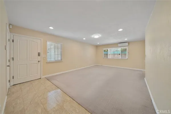 an empty room with a empty space and windows