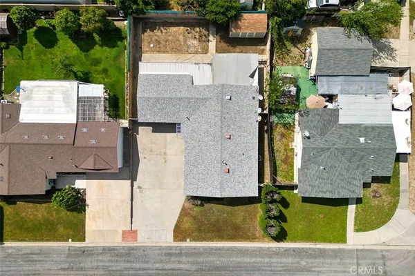 an aerial view of a house with a yard
