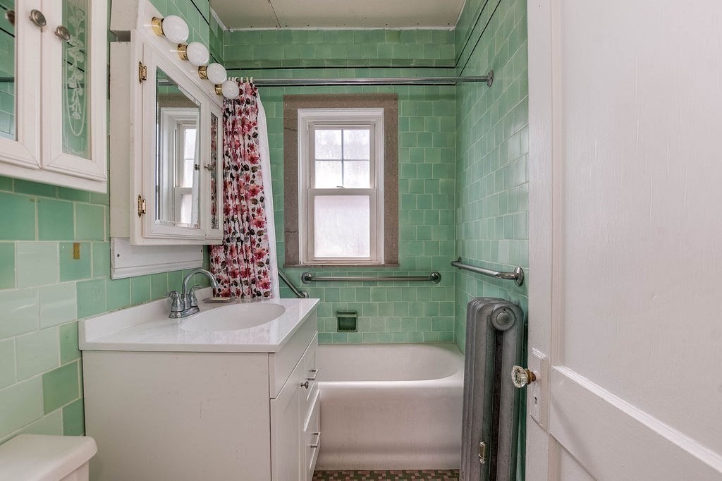 73 Westbourne Street Boston, MA 02131 - Photo 11 of 41 a bathroom with a sink a toilet and a bathtub