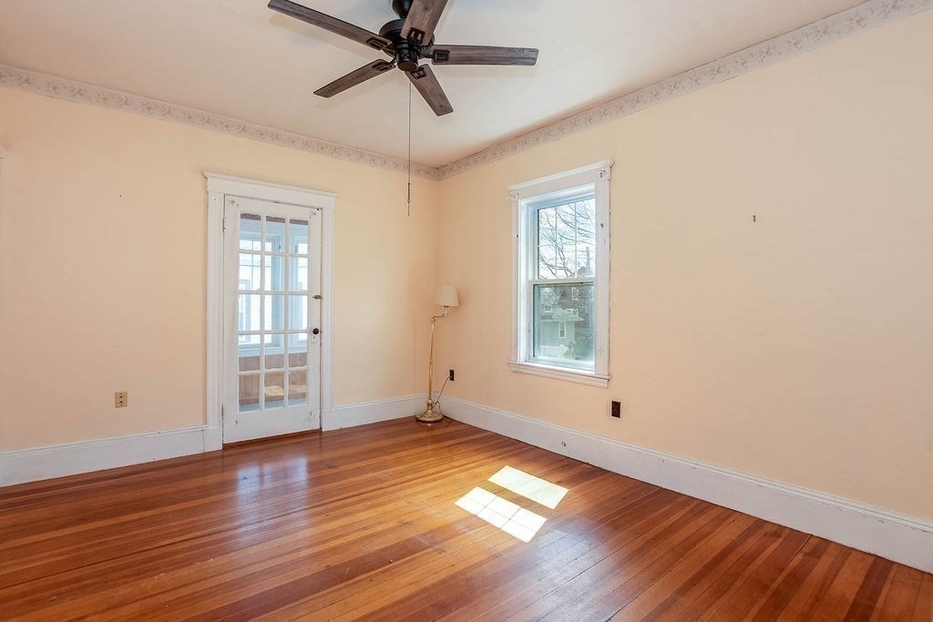 73 Westbourne Street Boston, MA 02131 - Photo 12 of 41 a view of an empty room with wooden floor and a window