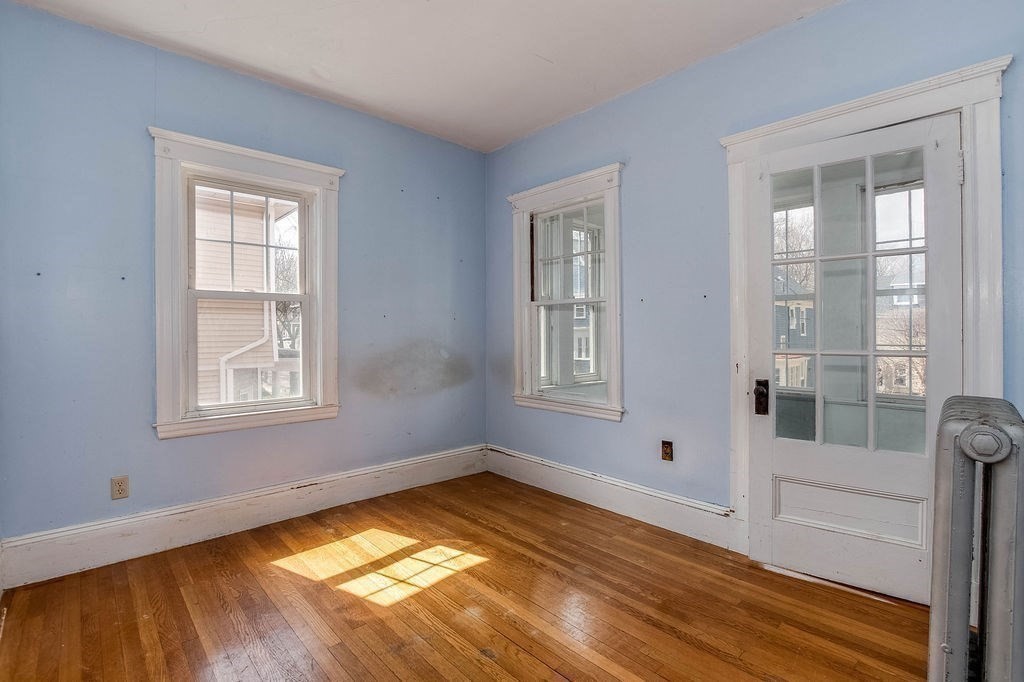 73 Westbourne Street Boston, MA 02131 - Photo 16 of 41 a view of empty room with wooden floor and fan