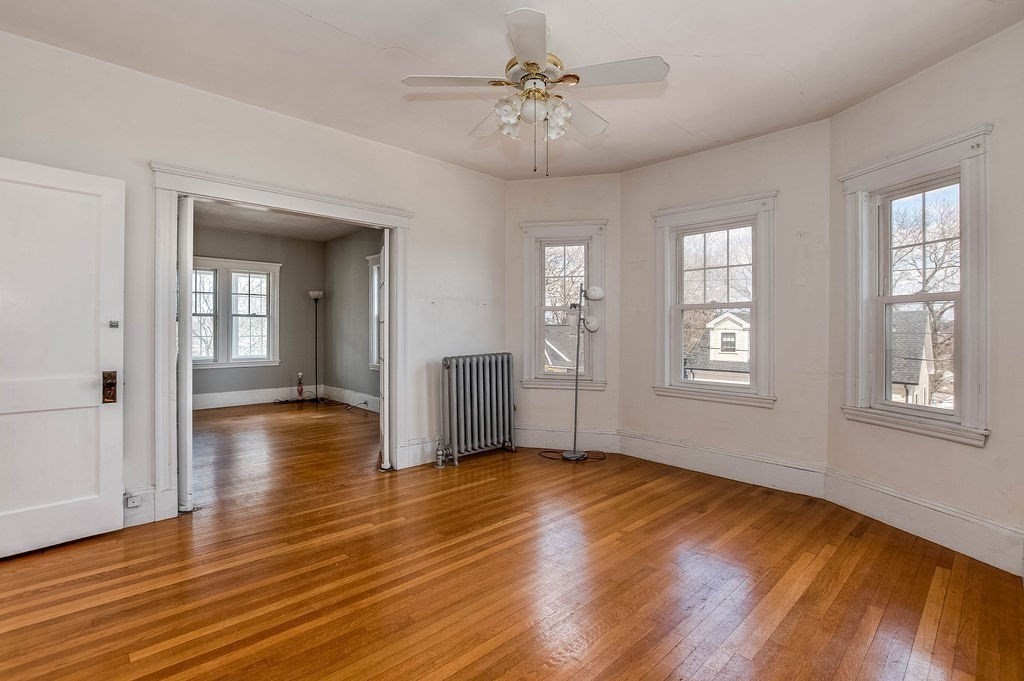73 Westbourne Street Boston, MA 02131 - Photo 18 of 41 an empty room with wooden floor and windows