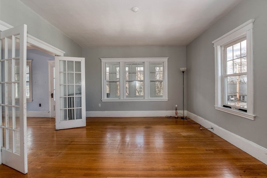 73 Westbourne Street Boston, MA 02131 - Photo 19 of 41 a view of an empty room with wooden floor and a window