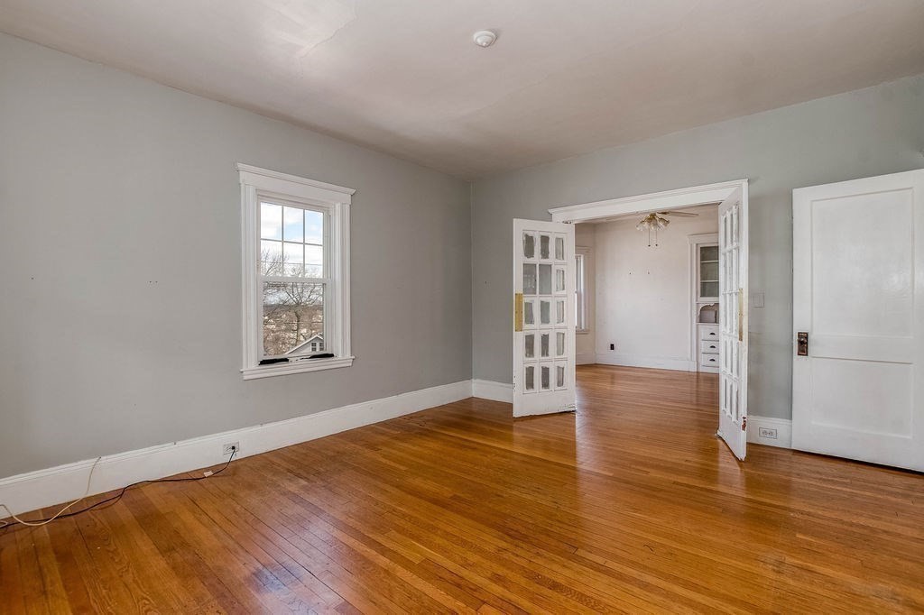 73 Westbourne Street Boston, MA 02131 - Photo 20 of 41 an empty room with wooden floor and windows