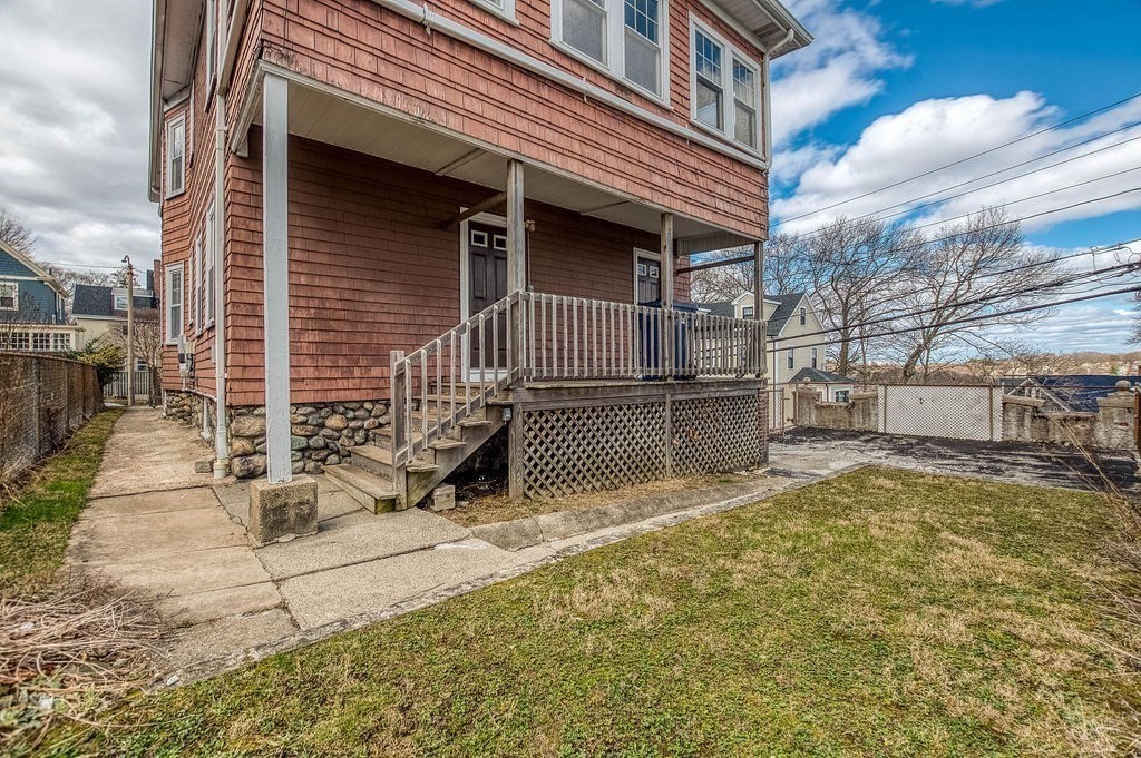 73 Westbourne Street Boston, MA 02131 - Photo 25 of 41 a view of a house with a wooden fence