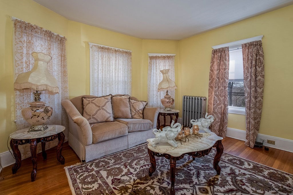 73 Westbourne Street Boston, MA 02131 - Photo 27 of 41 a living room with furniture and a wooden floor