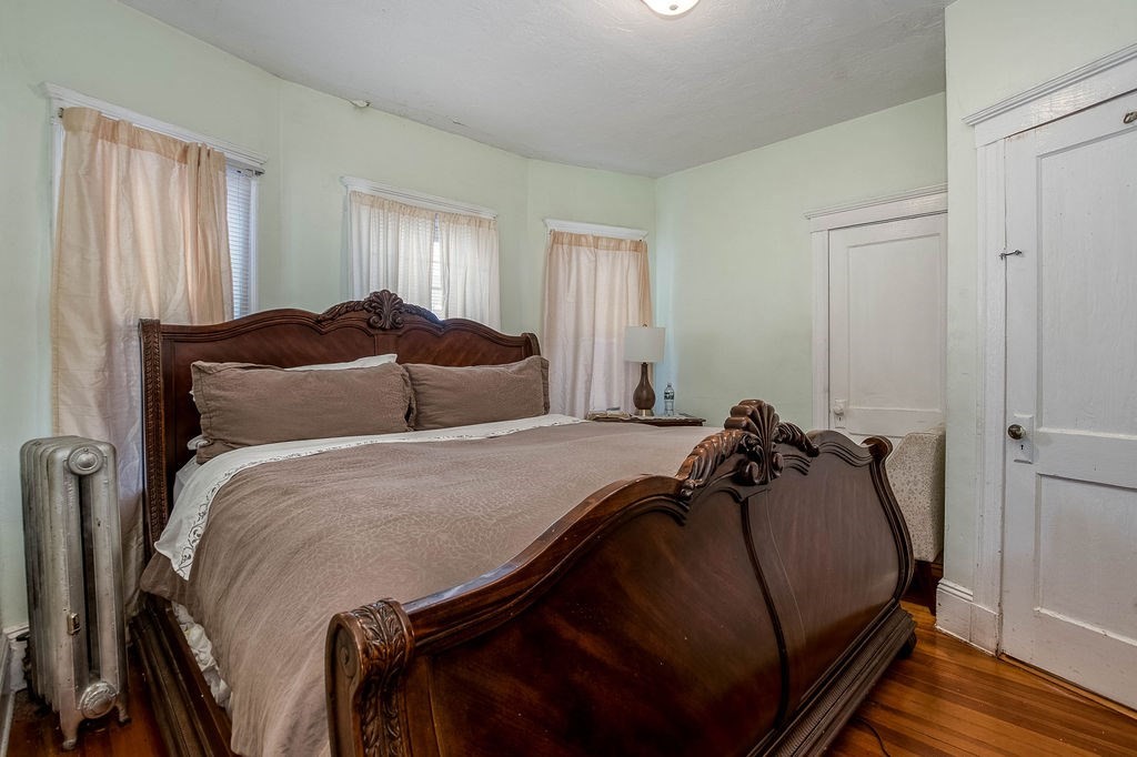 73 Westbourne Street Boston, MA 02131 - Photo 33 of 41 a bedroom with a bed and wooden floor