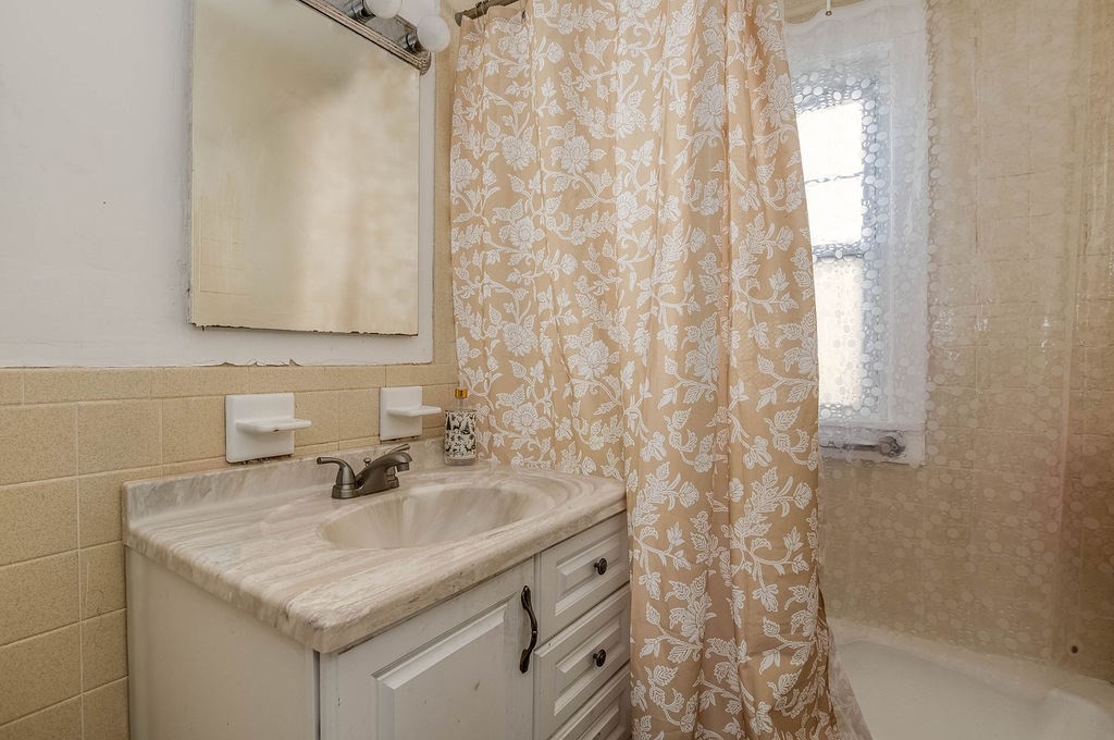 73 Westbourne Street Boston, MA 02131 - Photo 34 of 41 a bathroom with a sink and a mirror