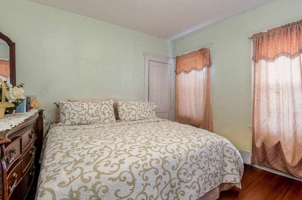 73 Westbourne Street Boston, MA 02131 - Photo 35 of 41 a large bed sitting in a bedroom next to a window