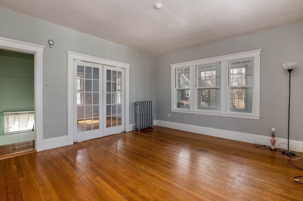 73 Westbourne Street Boston, MA 02131 - Photo 4 of 41 a view of an empty room with wooden floor and a window