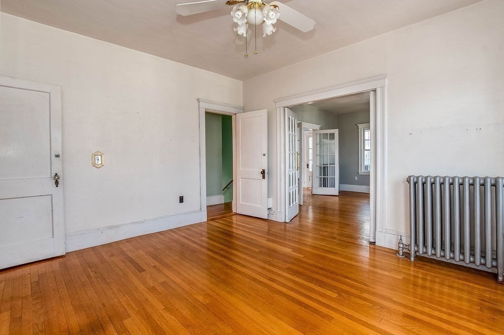 73 Westbourne Street Boston, MA 02131 - Photo 5 of 41 wooden floor in an empty room with a window